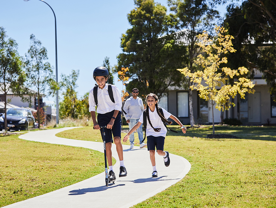 Maple Grove, Pakeham school kids riding scooter and running with father walking not too far behind v3.