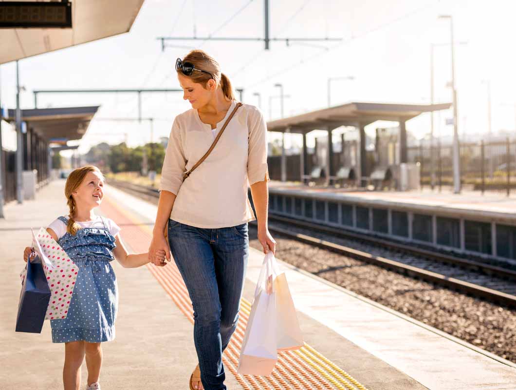 True North, Greenvale mother and daughter walking along train station platform.