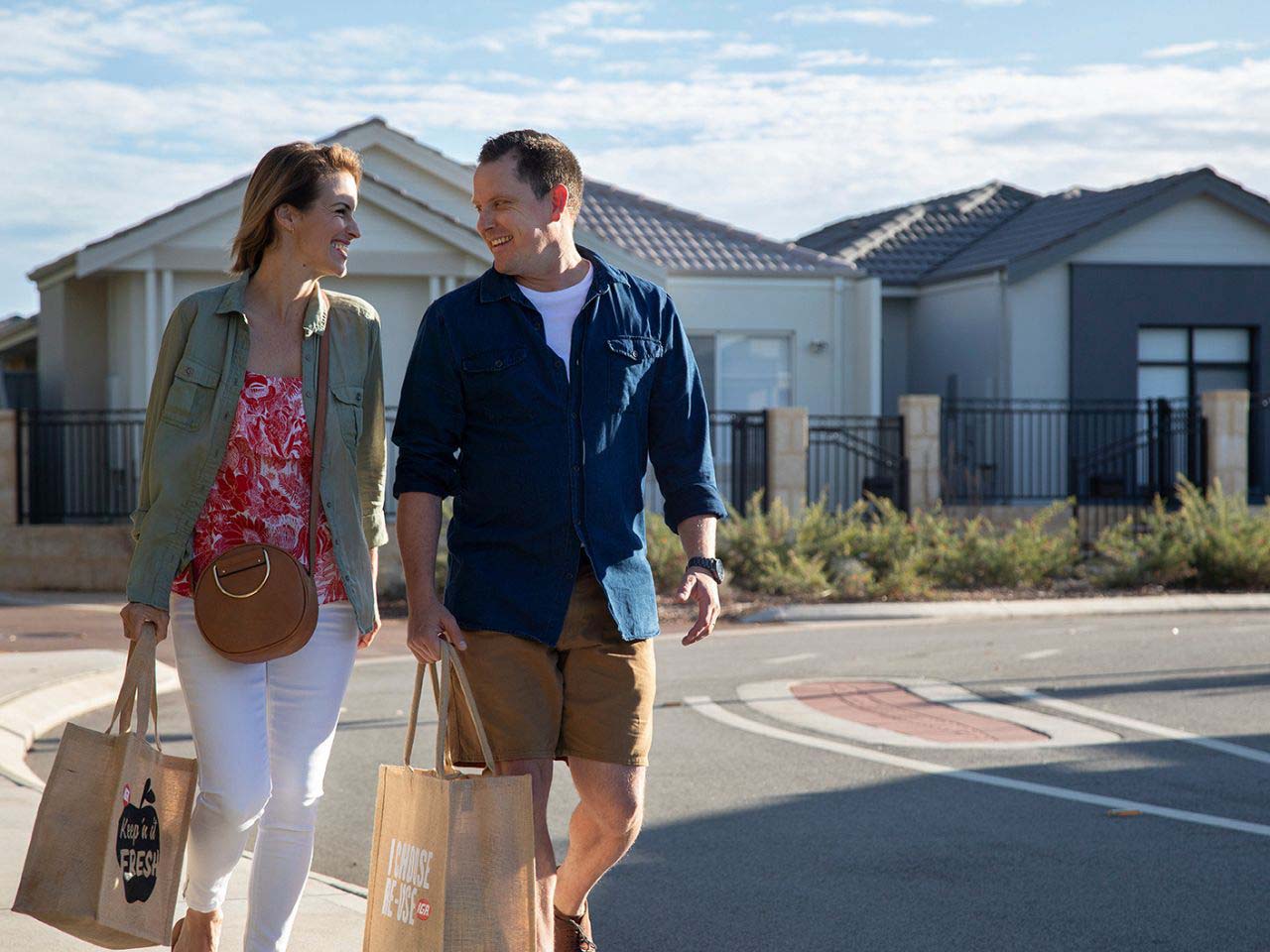 Cassia, Kwinana young couple walking along the street with shopping in their hand