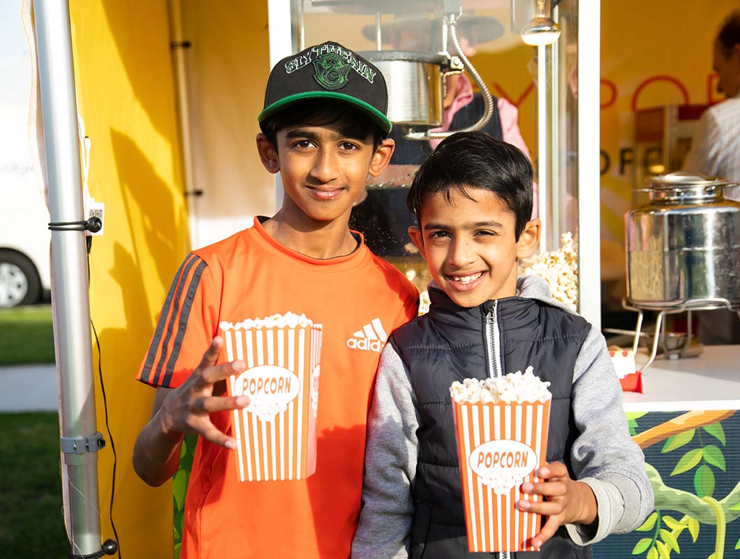 Arcadia, Officer community event, children smiling with pop corn in hand
