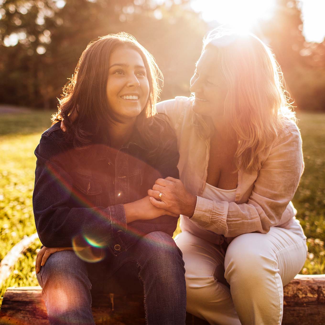 Mother and daughter sitting outside