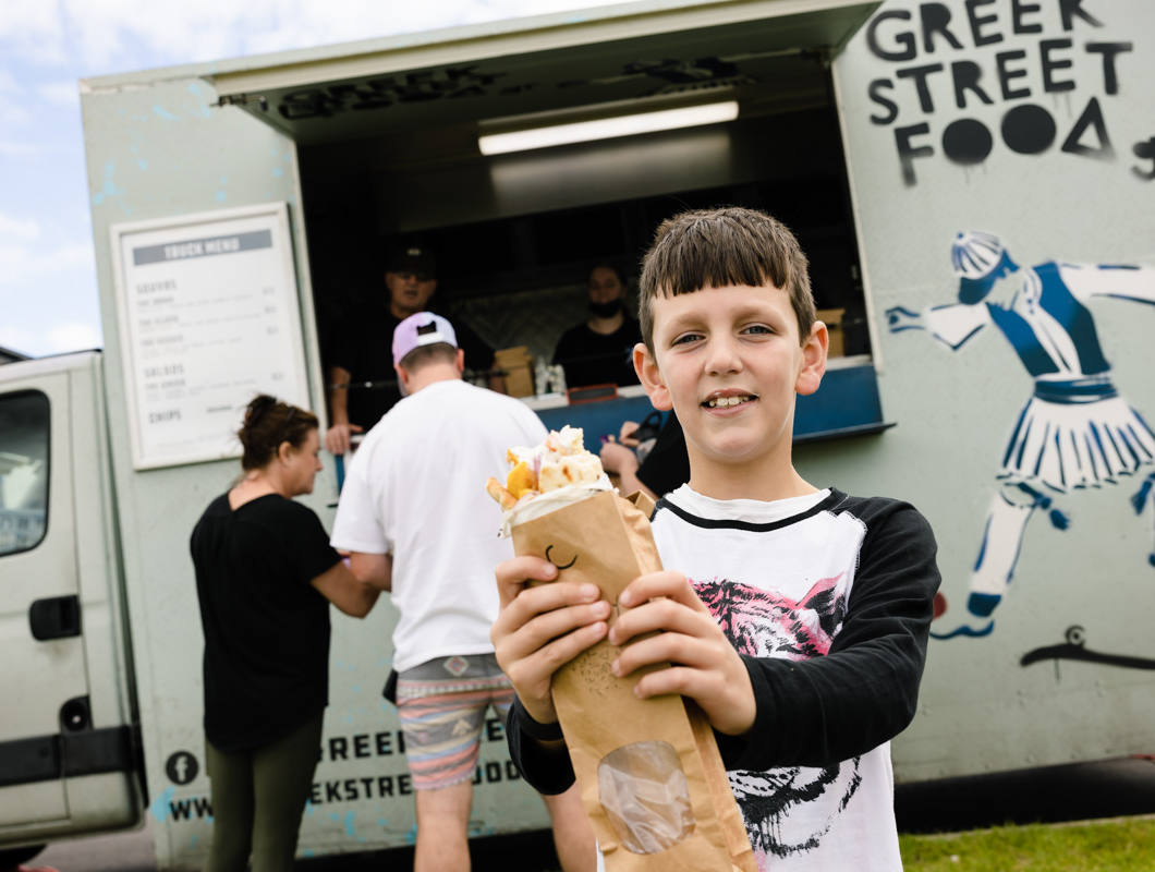 True North, Greenvale community event, young child excited to eat from Greek Street Food truck.