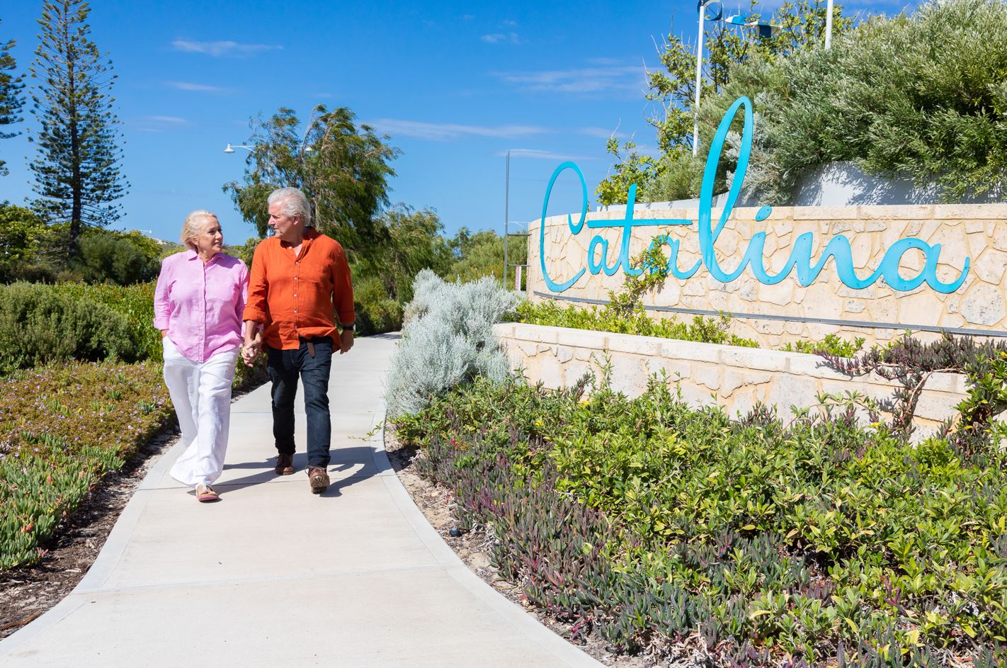 Catalina, Mindarie and Clarkson retirees walking along the foot path next to the Catalina Beach entry statement