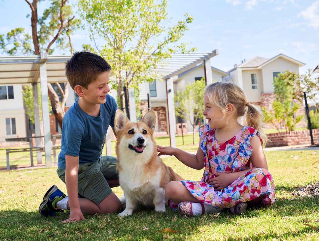 Clementine children outdoors, patting their dog