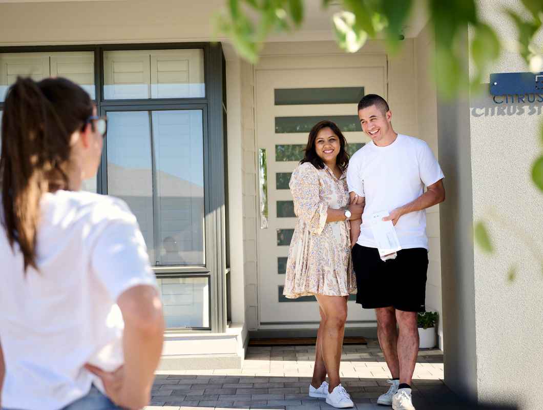 Couple accepting keys to their new home in Clementine