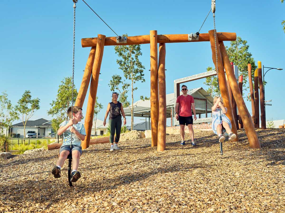 Young family playing on play equipment in Clementine in Upper Swan