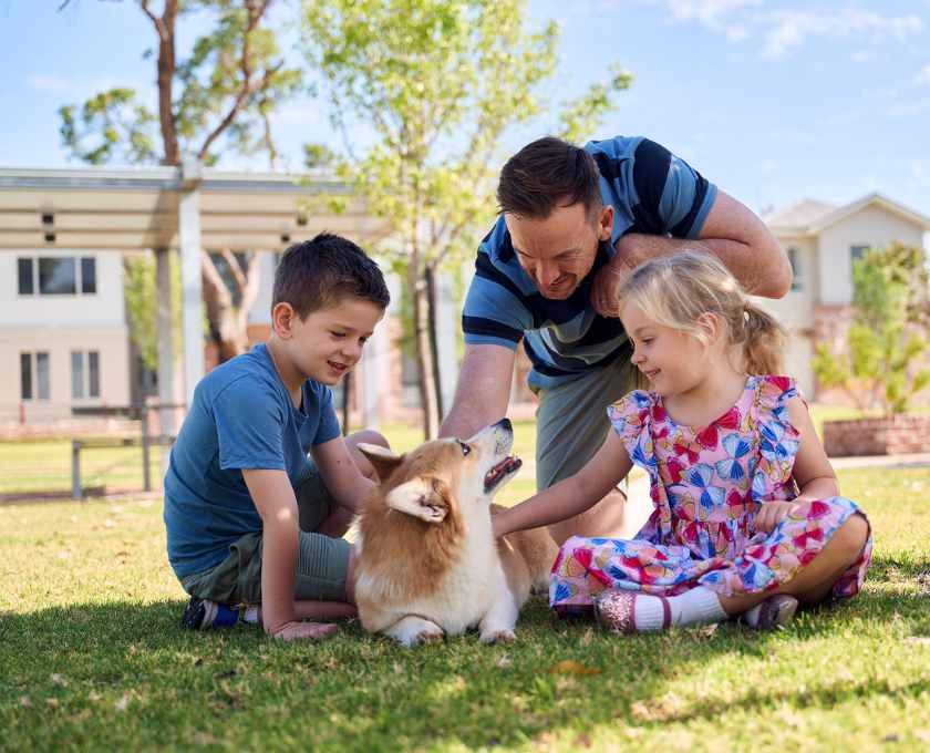 Young children with their father and dog sitting on the lawn at Clementine, Upper Swan
